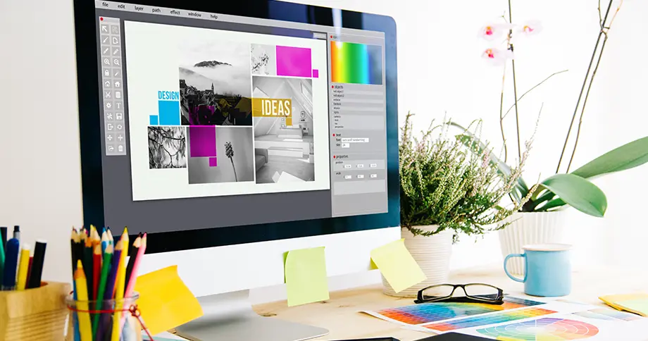 Grafikdesigner arbeitet am Computer an kreativem Design-Layout – individuelles Exposé gestalten mit professioneller Software.